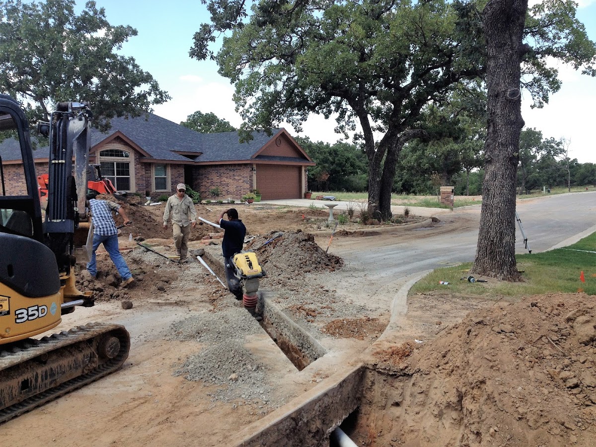 Big Country Plumbing crew excavating a sewer line at a residential property
