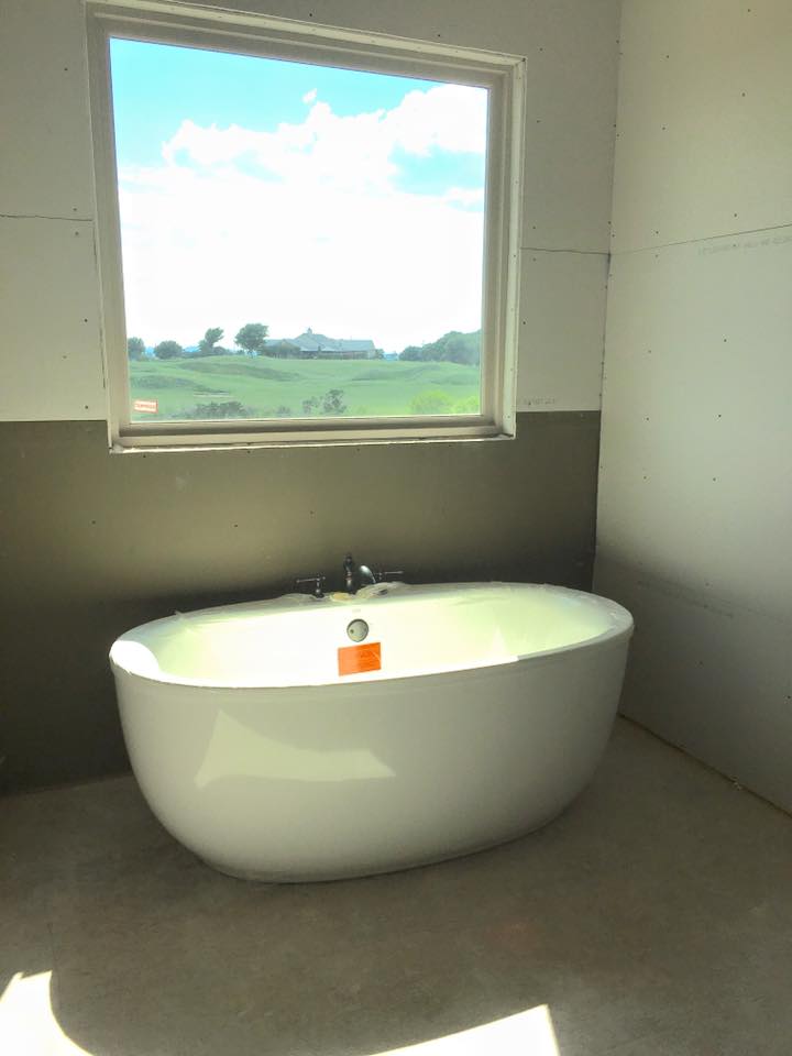 Freestanding soaking bathtub installed in new construction